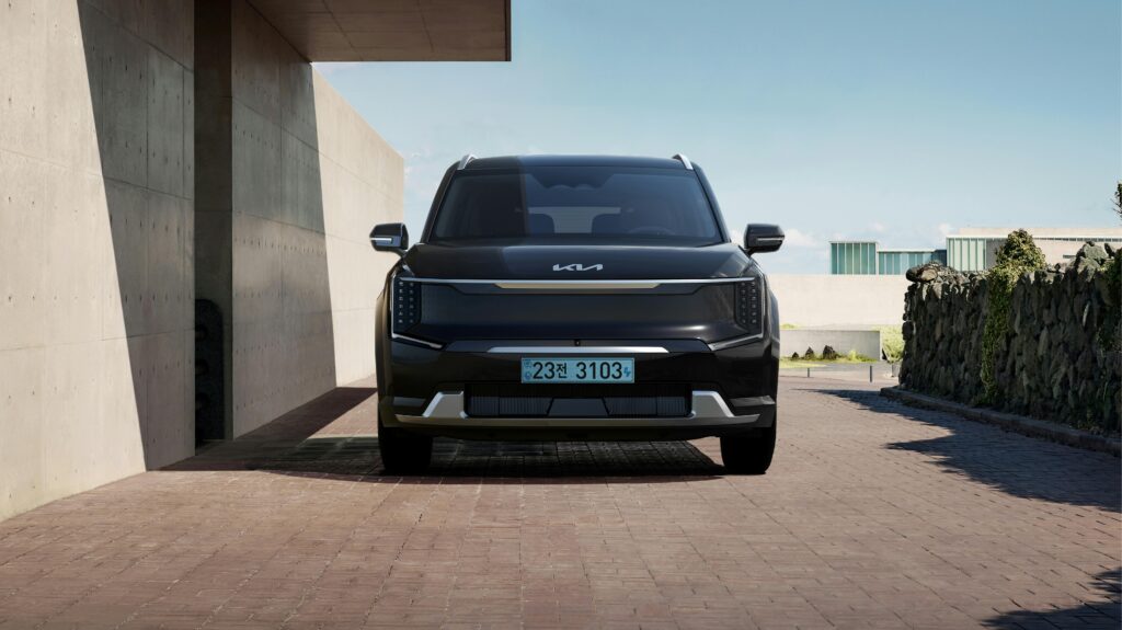 Sleek black electric SUV parked in a contemporary architectural environment.
